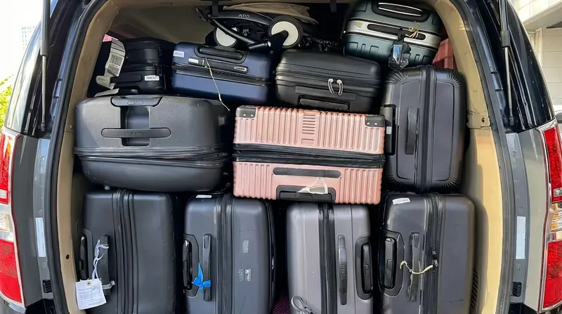 Luggage loaded into the back of a private van
